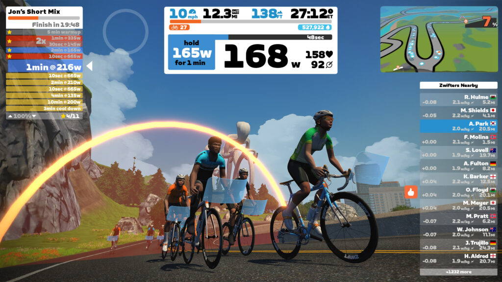 Zwift group ride during a structured workout climb with power targets displayed.