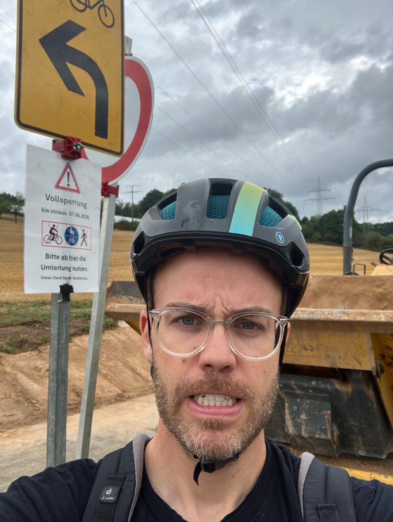 DTour-BadOrb-2026-constructionsite Angry dad at construction site at cycling path.