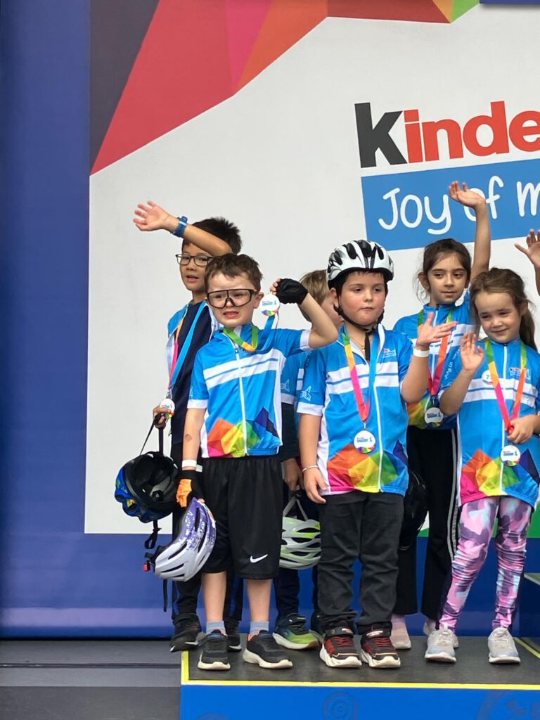 DTour-BadOrb-2026-podium Kids after the Joy of Moving Mini Tour Bike Parade.